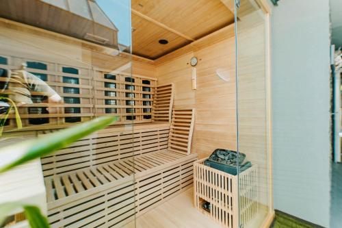 a sauna with a bird cage on the wall at Arena Deluxe & Spa in Szeged