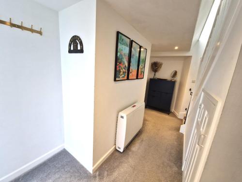 a hallway of a house with a white radiator at Very Spacious, Great location. Castle and Sea view in Marazion
