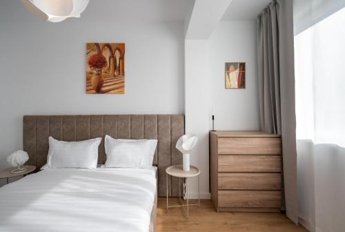 a bedroom with a large bed and a window at AeroPrime - LOFT in Tunari
