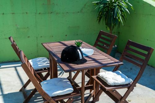 a wooden table with two chairs and a hat on it at Vila Agava, Konavle in Gruda