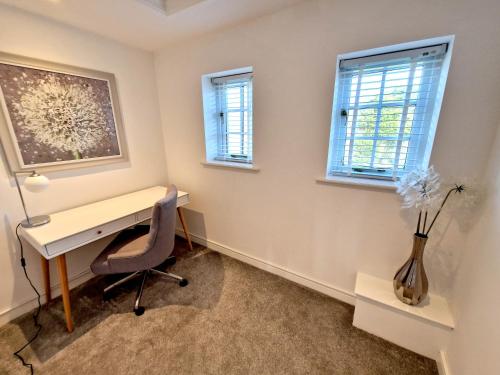 an office with a desk and a chair and windows at Very Spacious, Great location. Castle and Sea view in Marazion