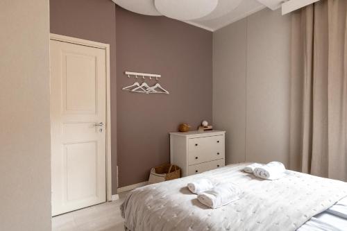 a bedroom with a bed with towels on it at Spacious 5BR Apartment with Best Location in Kamppi in Helsinki