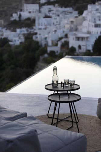 a table with three cups and a vase on it at House G in Kardiani Tinos in Kardiani