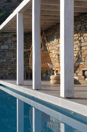 a basket sitting on a porch next to a swimming pool at House Y in Kardiani Tinos in Kardiani