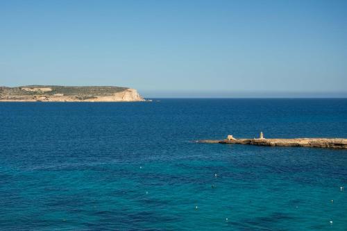 an island in the middle of a large body of water at Riviera Spa Resort - Adults Only in Mellieħa