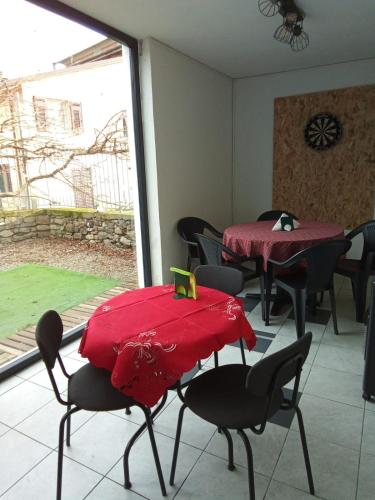 a dining room with two tables and chairs and a window at Relax Brugnato in Brugnato