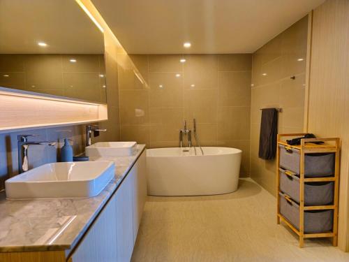 a bathroom with two sinks and a bath tub at Wonderful View Duplex in La Vita in Rawai Beach