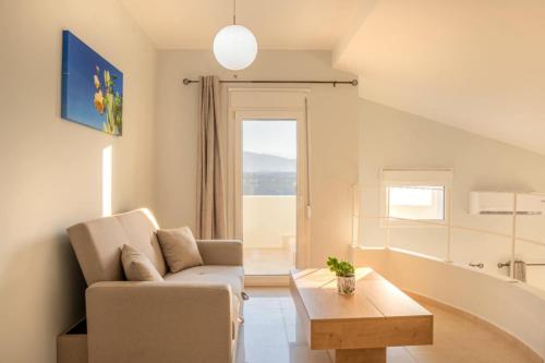 a living room with a couch and a coffee table at Villa Helyra in Heraklio Town