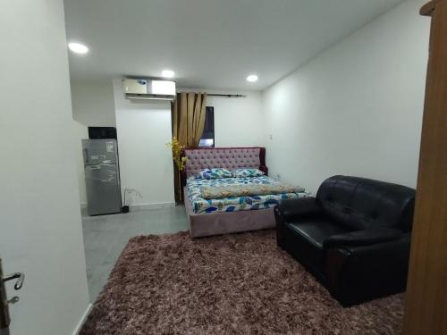 a living room with a couch and a chair at JUH Real Estate and management servise LLC in Abu Dhabi