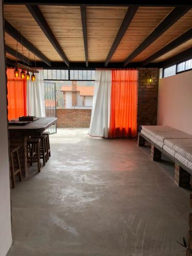 a large room with a table and benches in it at Posada María E in Mucuchíes