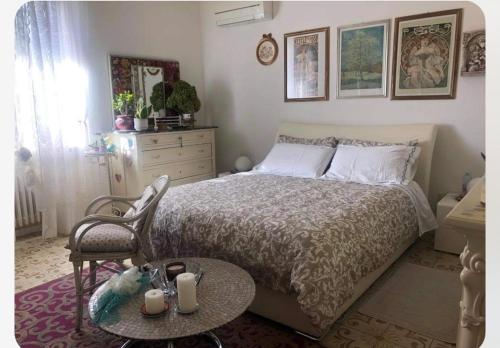 a bedroom with a bed with a table and a chair at B & B Da Giusy in Corte Franca