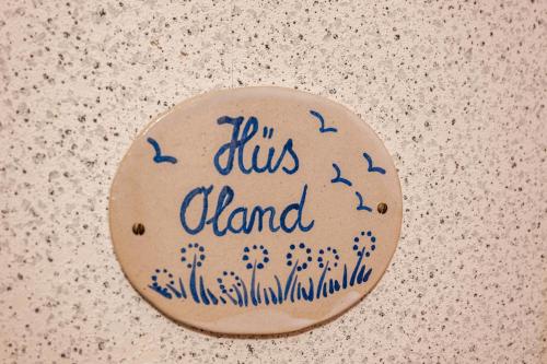 a rock with a sign that says i in a bus channel at Gästehaus Bi de Ley in Langeneß