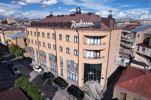 a building with a sign on the top of it at Radisson Hotel & Spa Gyumri in Gyumri
