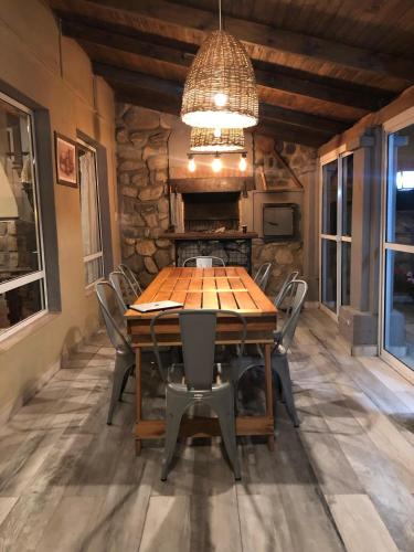a dining room with a wooden table and chairs at Los ciruelos - Casas de Motaña in Tafí del Valle