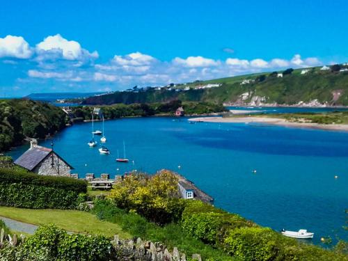 a view of a large body of water with boats in it at Carew in the heart of Bantham with panoramic sea views in Bantham