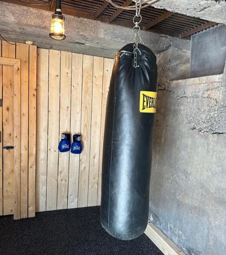 a black punching bag hanging from a wall at Hvammsvík Nature Resort in Kjósahreppur
