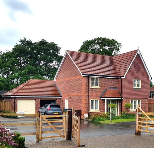 a house with a car parked in front of it at 8 Hazel Close in Arundel