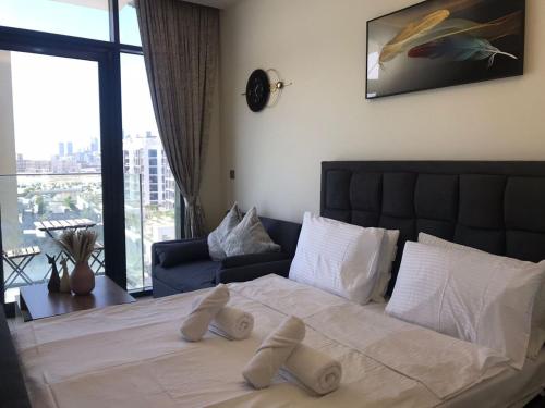 a bedroom with a large bed with white pillows at Pet Free Studio Apartment Close Downtown Fast Wi-fi in Dubai
