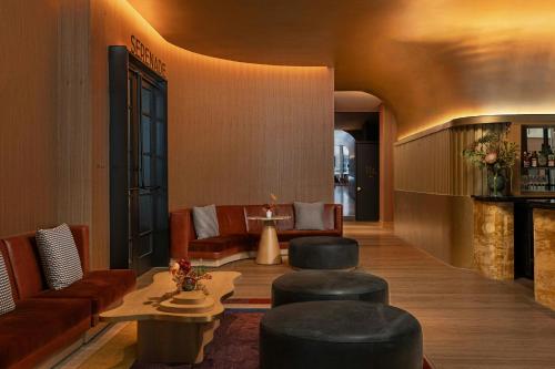 a lobby with couches and chairs and a table at W Austin in Austin