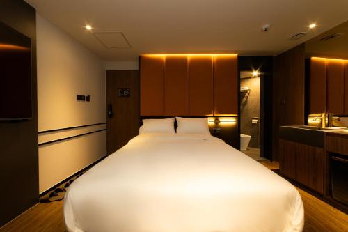 a large white bed in a hotel room at Guwol Hotel in Seoul