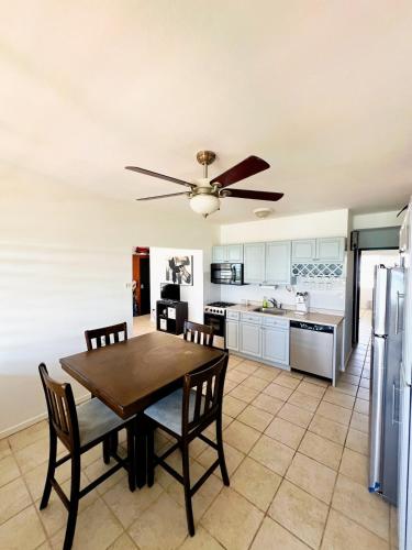 a kitchen and dining room with a table and chairs at Beachfront at Cabo Rojo in Cabo Rojo
