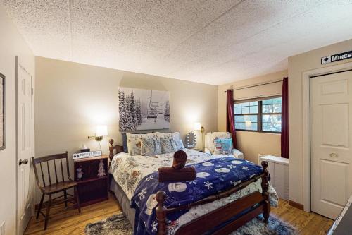 a bedroom with a bed and a chair in it at On Lake Time in Lake Harmony