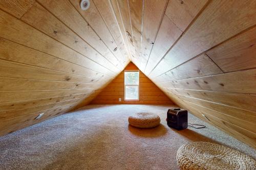 a large wooden room with a bed and a speaker at The Cozy Timber in Lake Arrowhead