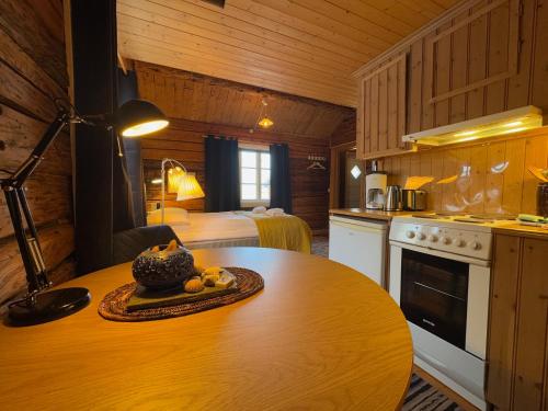 a kitchen with a table with a bowl of fruit on it at Sakrisøy Rorbuer in Reine