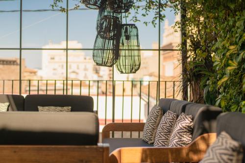 a living room with couches and a large window at The Valentia Cabillers in Valencia