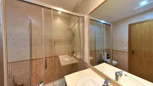 a bathroom with a sink and a shower and a toilet at Residencial Las Dunas, Best Holiday Home Resort On The Island- VV in Corralejo