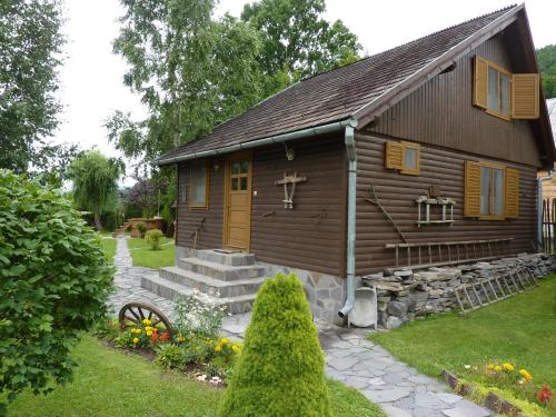 a small wooden church with a cross on the front of it at Nagy Lak I. in Sub Cetate