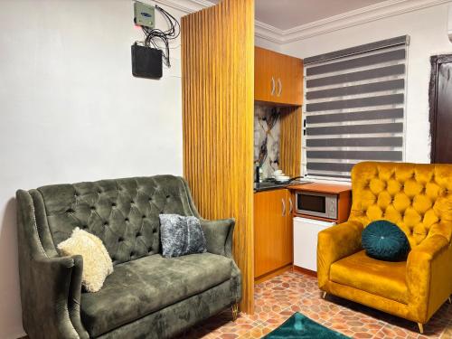 a living room with a couch and a chair at Cozy Twin 5 in Lekki