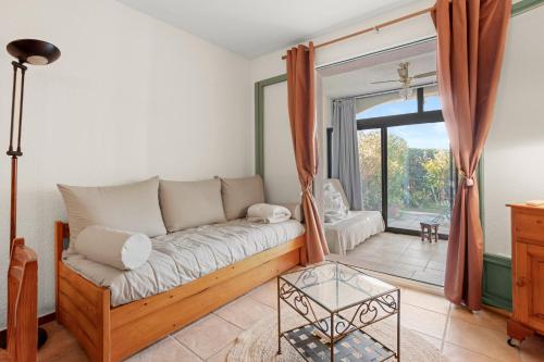 un salon avec un canapé et une fenêtre dans l'établissement Appartement Pramousiquer D23, à Rayol-Canadel-sur-Mer