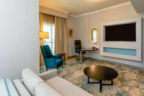 a living room with a couch and a television at Southern Sun Sandton in Johannesburg