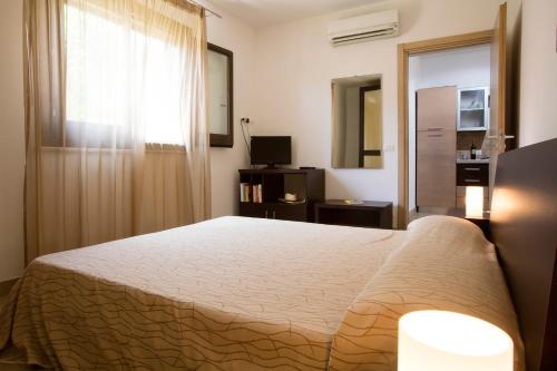 a bedroom with a large bed and a window at Il Borgo Del Principino in Favignana