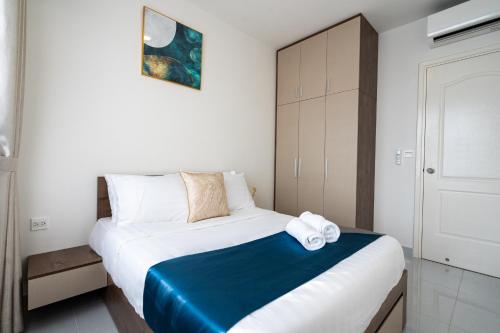 a bedroom with a bed with towels on it at Otis Soho Saigon Balcony Apartment in Ho Chi Minh City