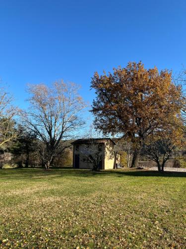 a building in the middle of a field with trees at Villaggio Della Salute Più in Monterenzio
