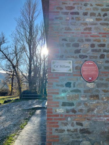 a brick wall with a sign on the side of it at Villaggio Della Salute Più in Monterenzio