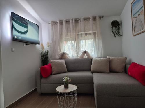 a living room with a couch and a flat screen tv at Apartments Duje in Split