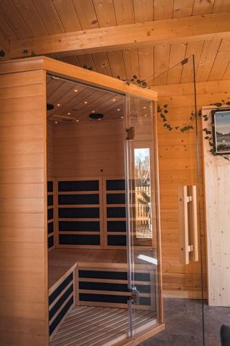 a sauna with a glass door in a cabin at Les Lodges de la Valière in Chorges