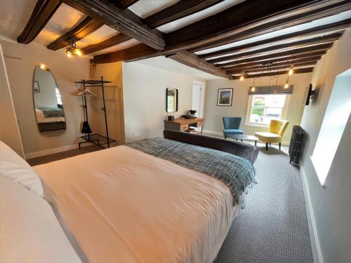 a bedroom with a large bed and a desk at The Marlborough Dedham in Dedham