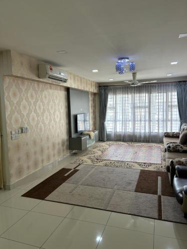 a large living room with a couch and a television at Maryam Homestay Putrajaya17 in Putrajaya