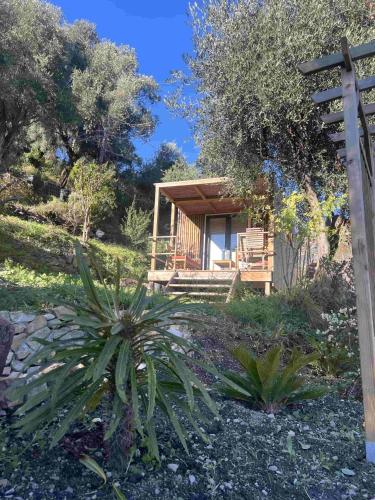 a log cabin in the middle of a garden at Le nid de l'oliveraie in Menton