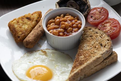 a plate of breakfast food with eggs beans and toast at Springfield House - Birmingham Airport & NEC in Coleshill