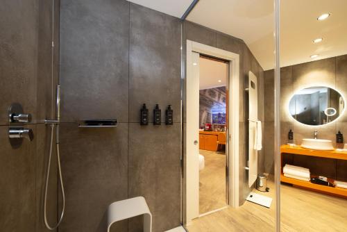 a bathroom with a shower and a sink at The Street Milano Duomo | a Design Boutique Hotel in Milan