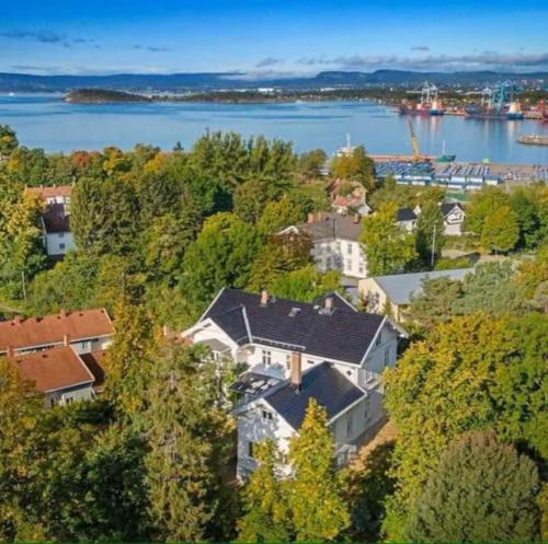 an aerial view of a house with a lake at Extravagant villa central & by the sea in Oslo