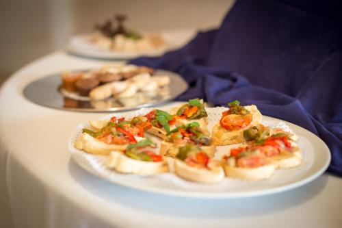two plates of food on a white table at Hotel Escuela Santa Cruz in Santa Cruz de Tenerife