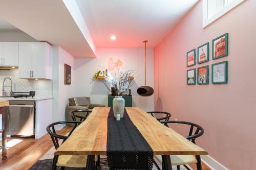 a kitchen and dining room with a wooden table and chairs at Modern 2BR Retreat, Close to DC & Airport in Arlington