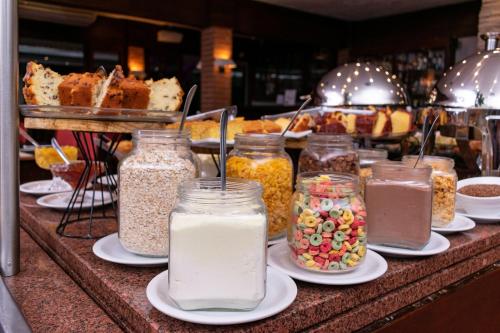 a counter with many jars of food and desserts at Hotel Colonial Iguaçu in Foz do Iguaçu