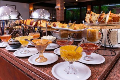 a buffet with many glasses of different types of food at Hotel Colonial Iguaçu in Foz do Iguaçu